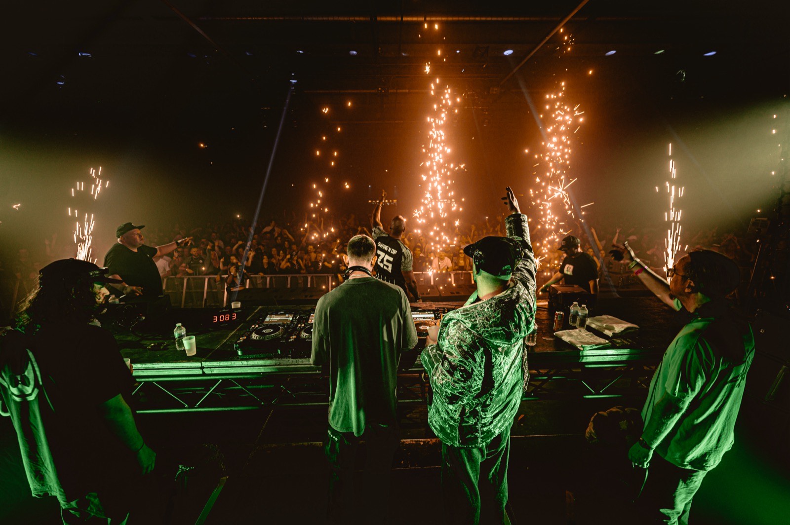 Antwerp Expo. DJs at the decks, sparkler pyro, packed crowd.